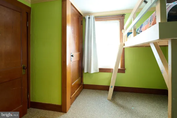 a view of a hallway with wooden floor and closet