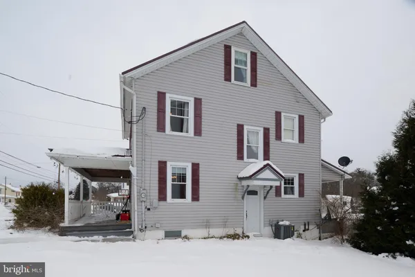 a front view of a house with snow