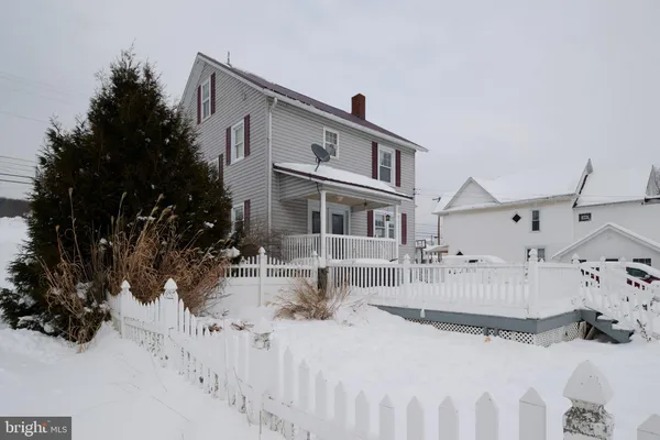 an outdoor sitting area with furniture and a garden