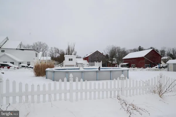 a view of a chairs and table in backyard
