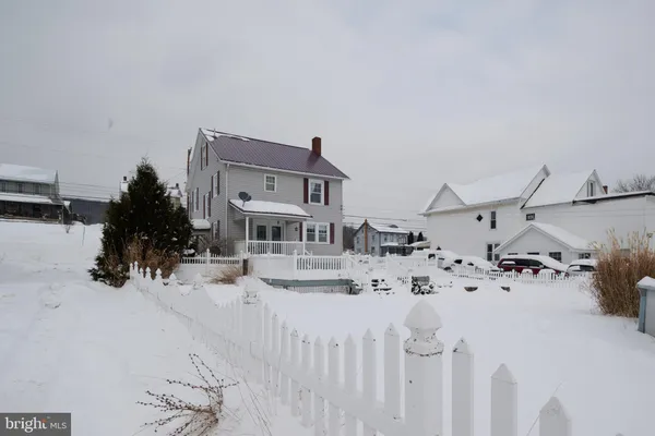 a view of a house with a snow in the yard
