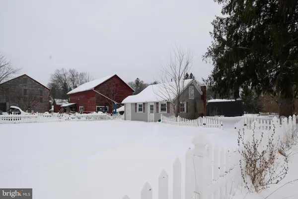 a view of a house with a yard covered in snow