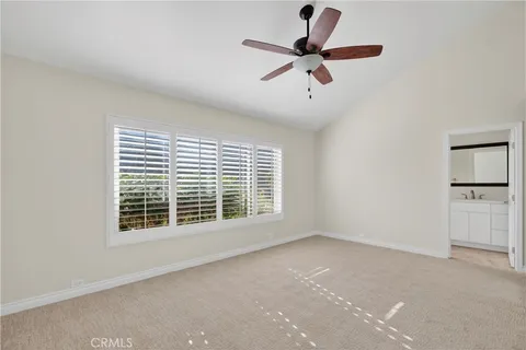 a view of a livingroom with a ceiling fan and window