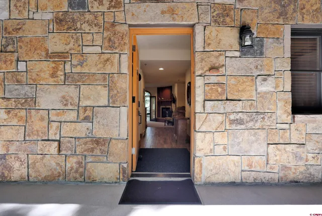 a bathroom with a granite countertop sink mirror and a toilet