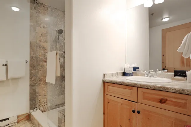 a bathroom with a double vanity sink and mirror