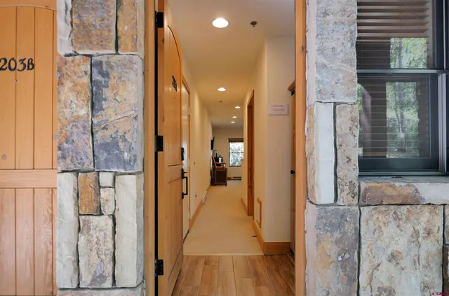 a bathroom with a granite countertop sink a mirror and shower