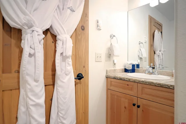 a bedroom with two beds and a flat screen tv