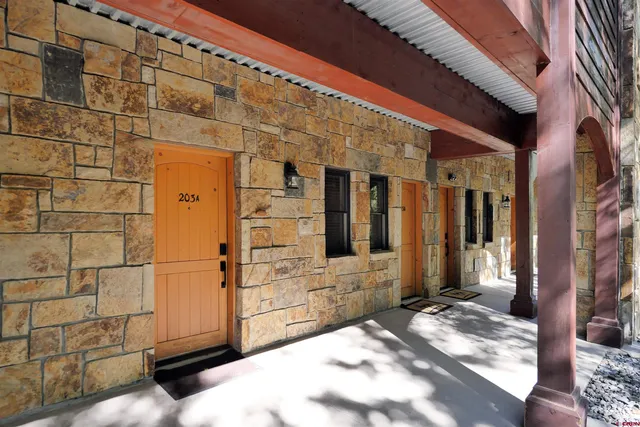 a view of balcony with wooden floor and trees