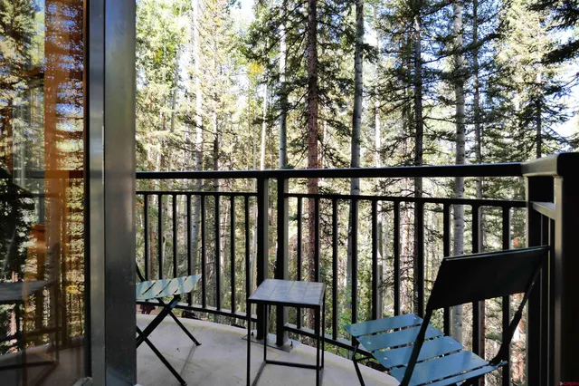 a view of trees from a balcony