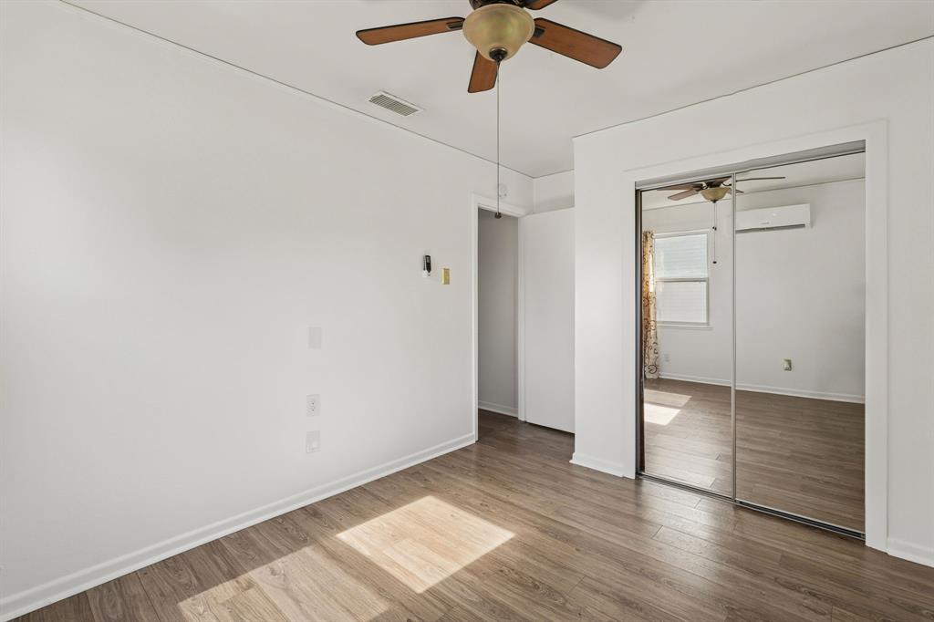 1822 Finley Road Irving, TX 75062 - Photo 25 of 38 an empty room with wooden floor closet and windows