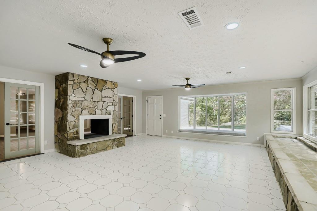 2021 Irwin Bridge Road Northwest Conyers, GA 30012 - Photo 23 of 43 a view of an empty room with a fireplace and a large window