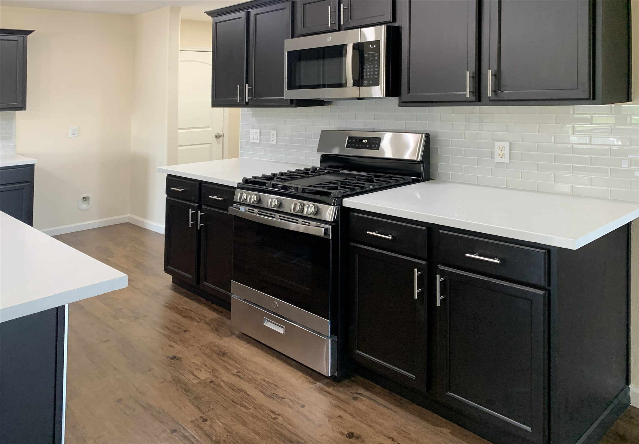 5612 Rainflower Terrace Lane Spring, TX 77389 - Photo 10 of 50 a kitchen with a stove microwave and sink