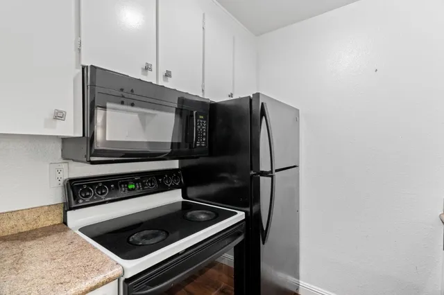 a kitchen with a stove and a microwave
