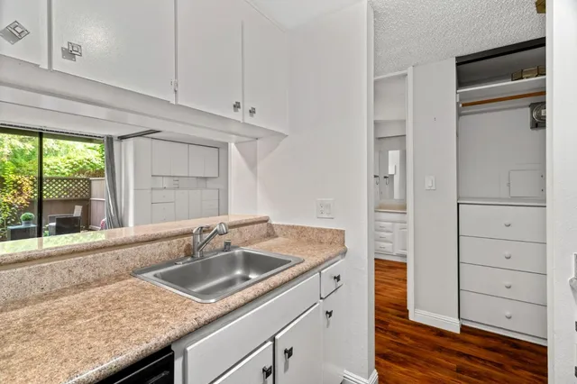 a kitchen with granite countertop a sink and a window