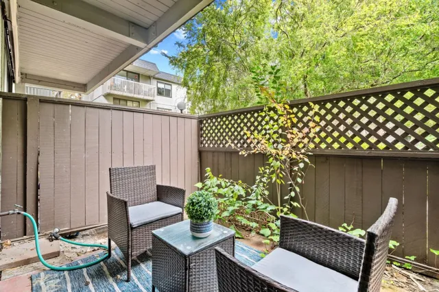 a outdoor living space with a couch and chairs