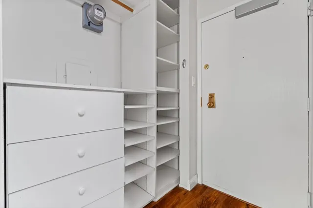 a view of walk in closet with empty racks