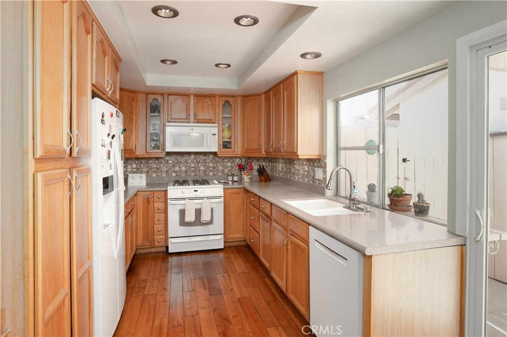 14302 Morning Glory Road Tustin, CA 92780 - Photo 14 of 38 a kitchen with stainless steel appliances granite countertop a sink stove and refrigerator