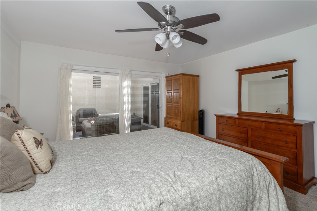 14302 Morning Glory Road Tustin, CA 92780 - Photo 16 of 38 a bedroom with a large bed and a chandelier