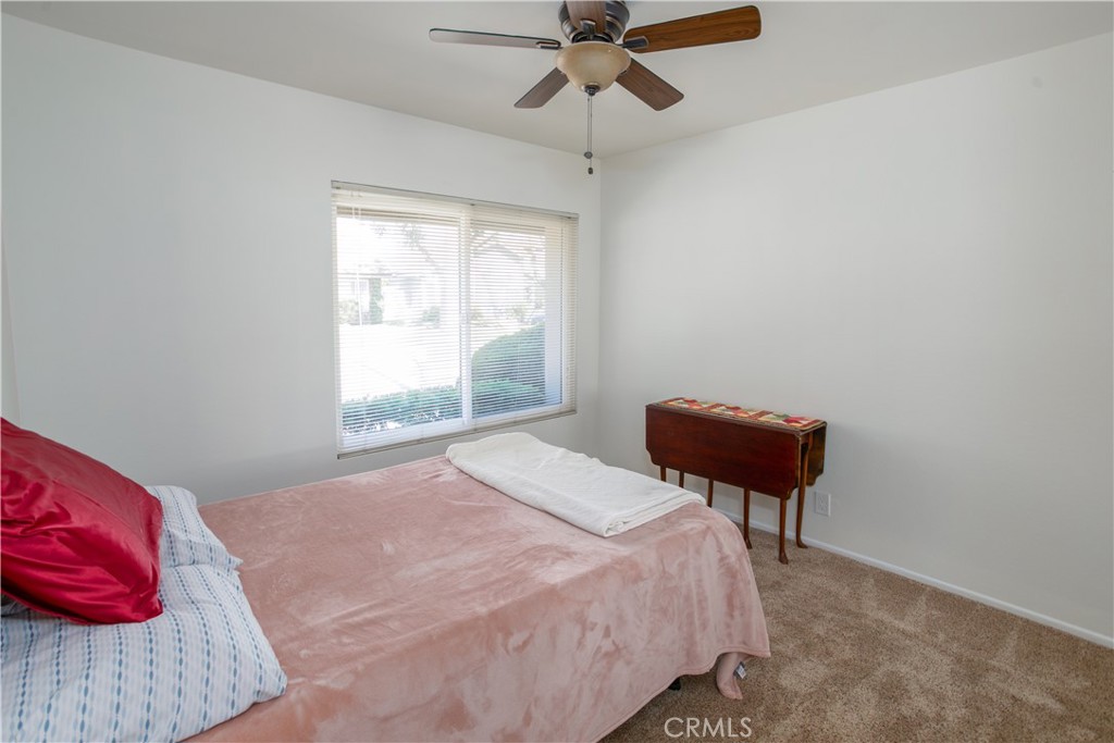 14302 Morning Glory Road Tustin, CA 92780 - Photo 21 of 38 a bedroom with a bed and a chandelier