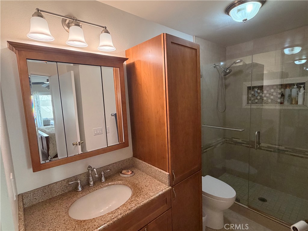 14302 Morning Glory Road Tustin, CA 92780 - Photo 22 of 38 a bathroom with a sink a toilet and shower