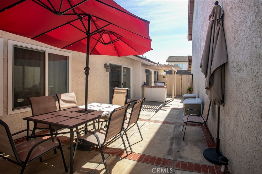 14302 Morning Glory Road Tustin, CA 92780 - Photo 28 of 38 a view of a patio with a table and chairs under an umbrella