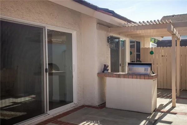 a view of a patio with table and chairs with wooden floor and fence