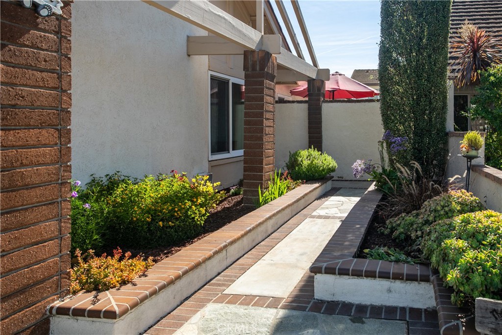 14302 Morning Glory Road Tustin, CA 92780 - Photo 3 of 38 a front view of a house having flowers