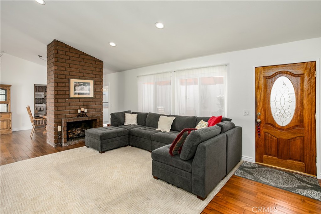 14302 Morning Glory Road Tustin, CA 92780 - Photo 5 of 38 a living room with furniture a fireplace and wooden floor