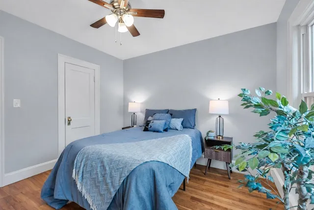 a bedroom with a bed and a potted plant
