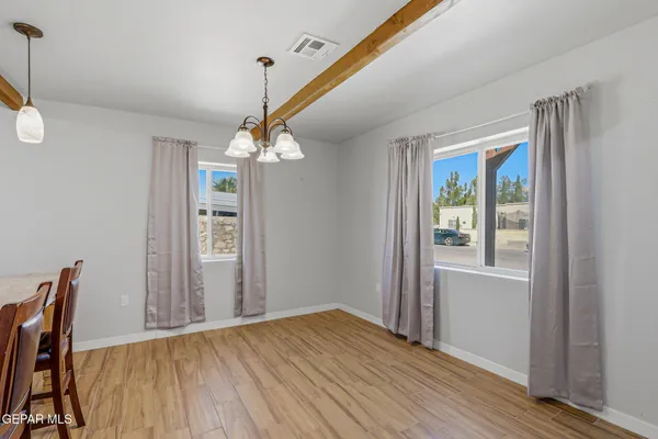 a view of a room with wooden floor staircase and a ceiling fan