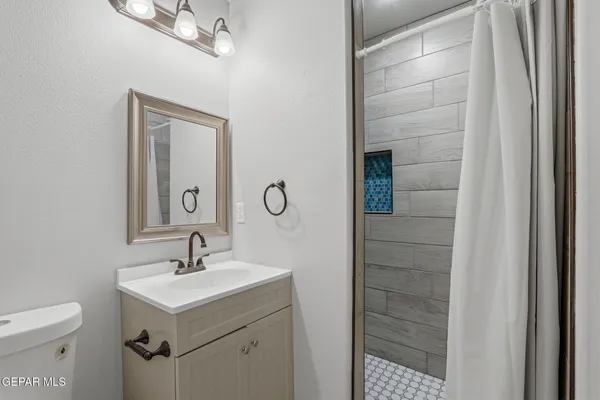 a bathroom with a sink toilet and shower