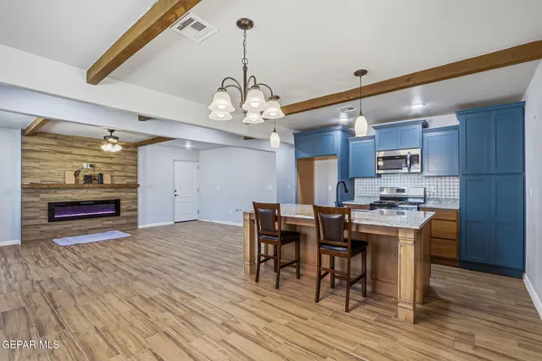 a view of a dining room with furniture wooden floor and chandelier