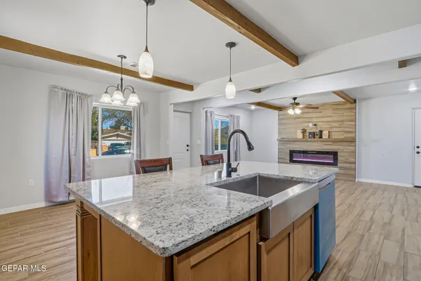 a kitchen with granite countertop a sink and center island