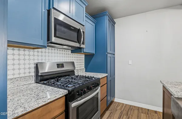 a kitchen with a stove and a microwave