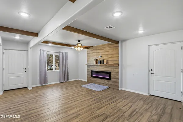 wooden floor in an empty room with a window