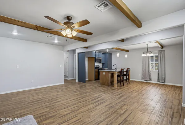 a view of a livingroom with furniture and a ceiling fan
