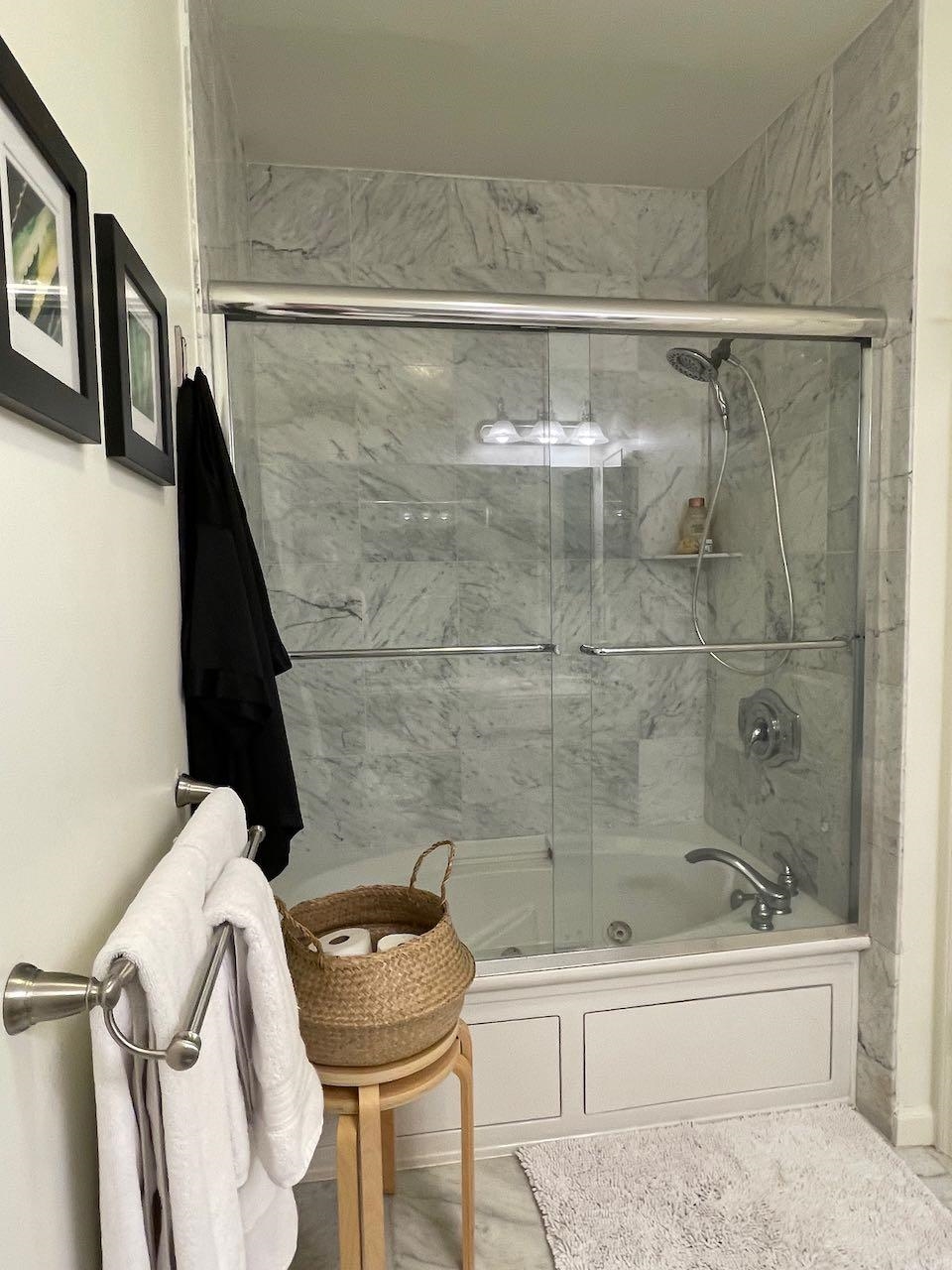 151 The Promenade Edgewater, NJ 07020 - Photo 4 of 6 a bathroom with a bathtub and a shower