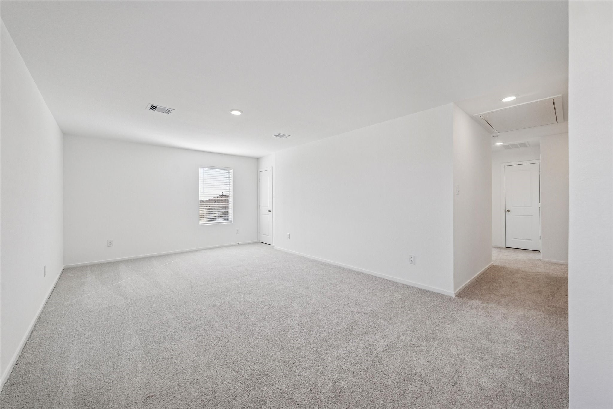 16207 Rustic Prairie Drive Hockley, TX 77447 - Photo 5 of 11 The oversized primary suite features plush carpet, soft natural light, and ample space to accommodate large furnishings or a cozy sitting area.