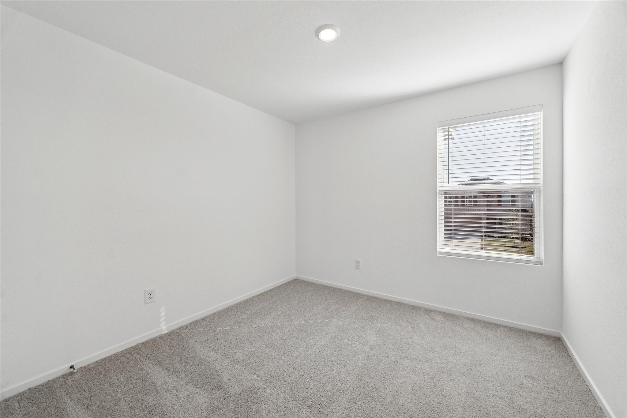 16207 Rustic Prairie Drive Hockley, TX 77447 - Photo 8 of 11 Another bright and inviting bedroom, complete with neutral tones and a large window, offers flexibility for use as a home office, nursery, or additional guest room.