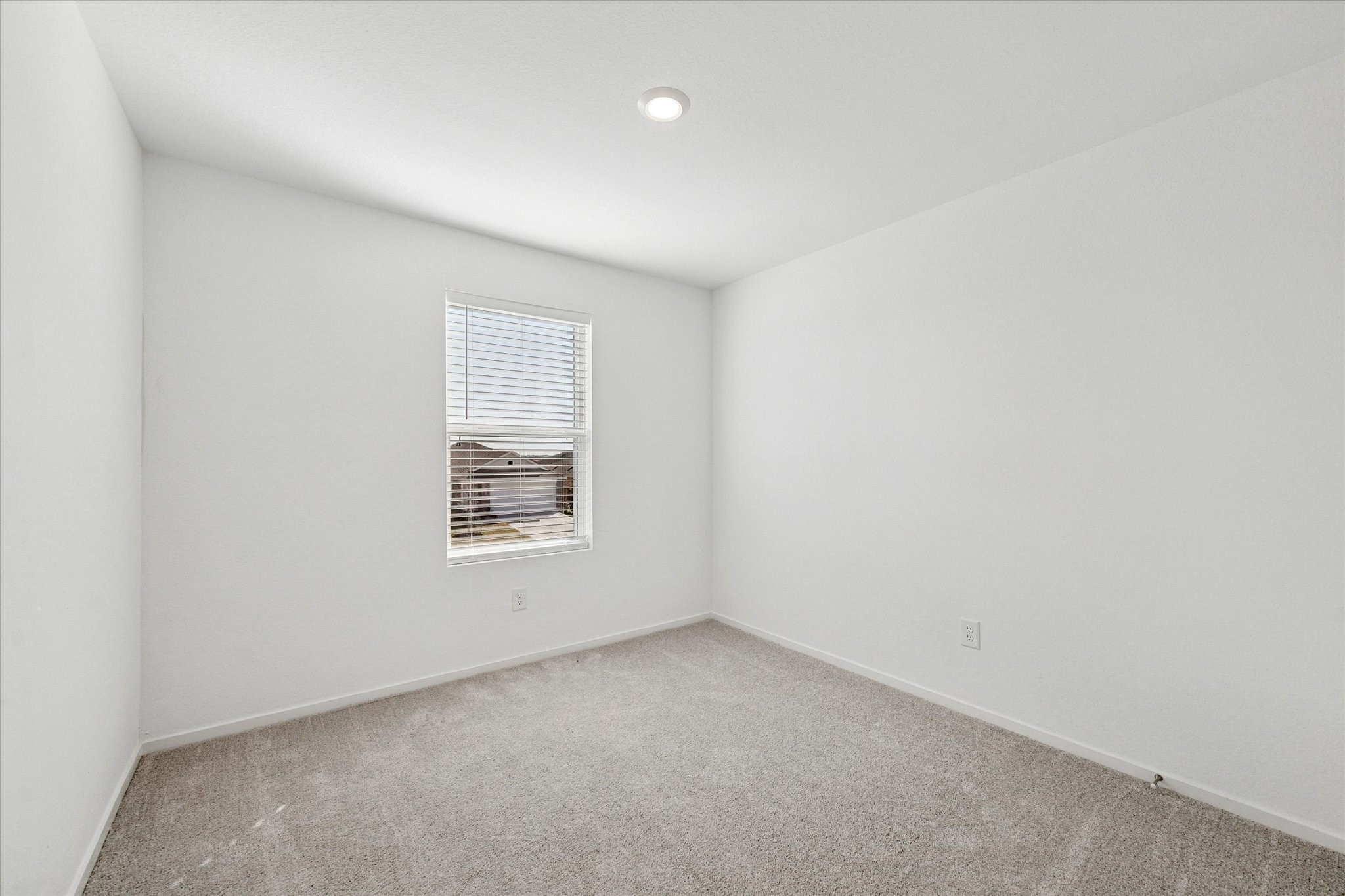 16207 Rustic Prairie Drive Hockley, TX 77447 - Photo 9 of 11 The third secondary bedroom continues the theme of soft, neutral finishes and natural light—ideal for family, guests, or creative use as a study or hobby space.