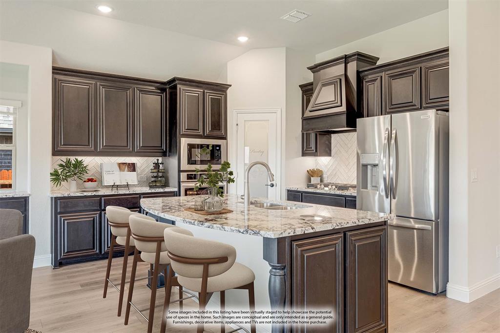960 Imperial Eagle Road Alvarado, TX 76009 - Photo 19 of 40 a kitchen with stainless steel appliances granite countertop a refrigerator and a stove top oven
