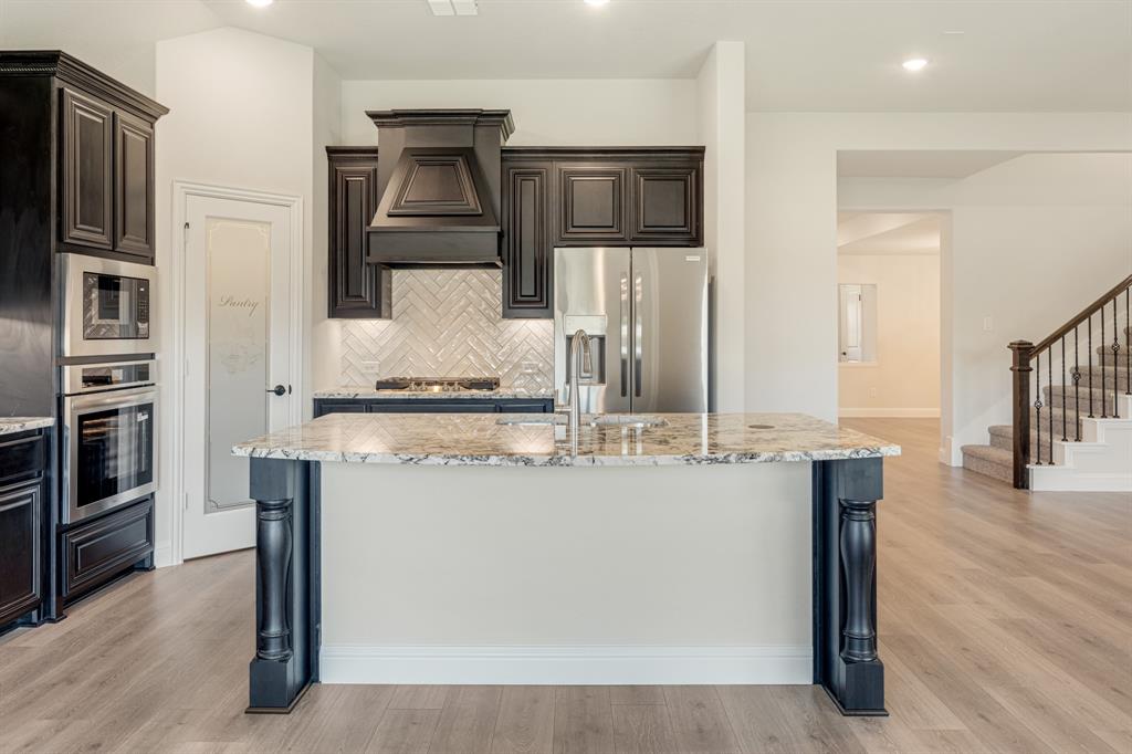 960 Imperial Eagle Road Alvarado, TX 76009 - Photo 20 of 40 a kitchen with stainless steel appliances granite countertop a sink and cabinets