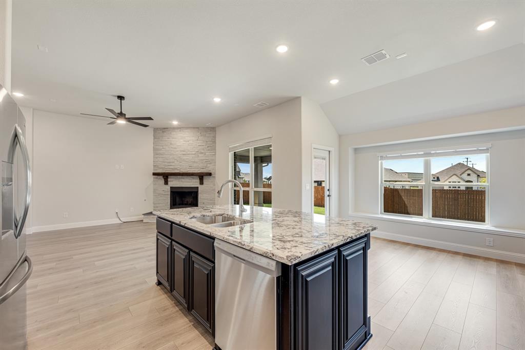 960 Imperial Eagle Road Alvarado, TX 76009 - Photo 22 of 40 an open kitchen with a sink and breakfast area
