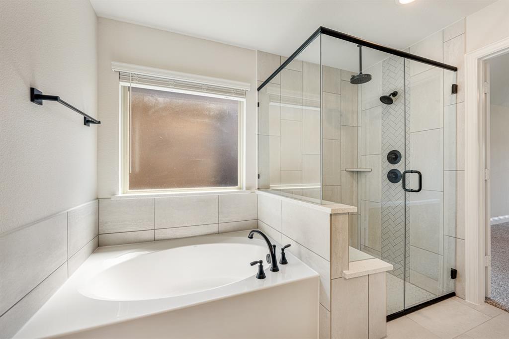 960 Imperial Eagle Road Alvarado, TX 76009 - Photo 27 of 40 a bathroom with a tub and a shower