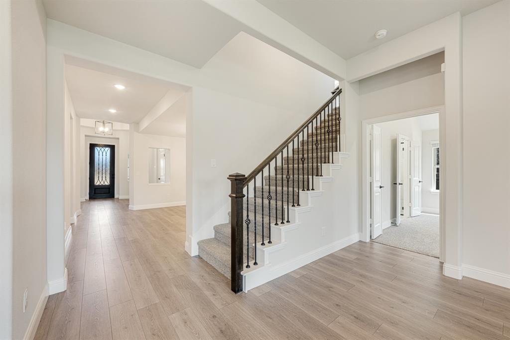 960 Imperial Eagle Road Alvarado, TX 76009 - Photo 28 of 40 a view of a hallway with wooden floor and stairs