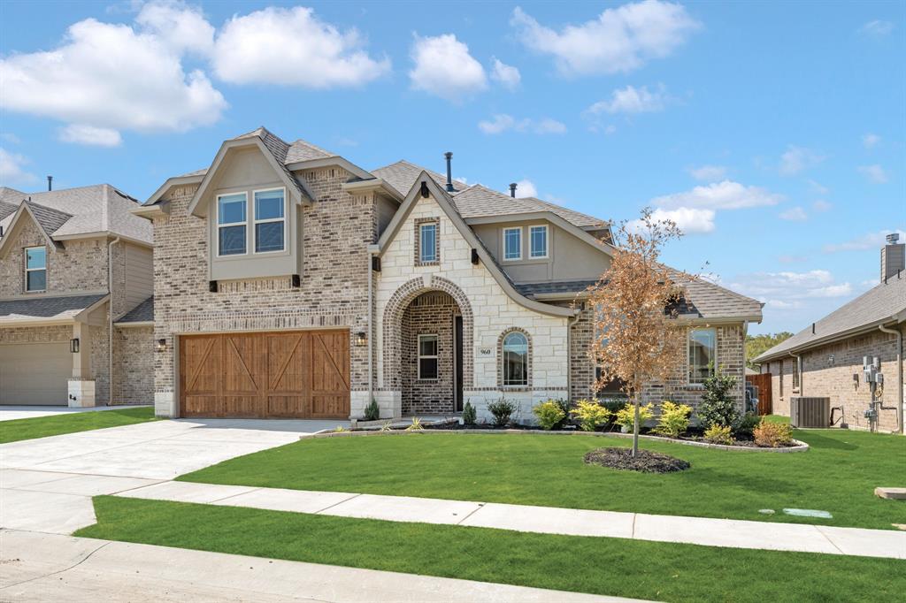 960 Imperial Eagle Road Alvarado, TX 76009 - Photo 3 of 40 a front view of a house with a garden