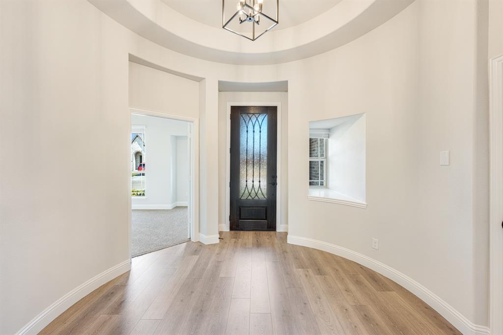 960 Imperial Eagle Road Alvarado, TX 76009 - Photo 5 of 40 an empty room with wooden floor and windows