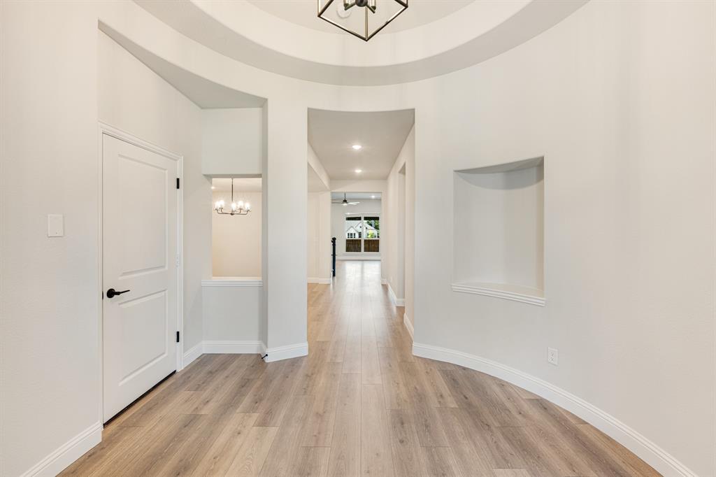 960 Imperial Eagle Road Alvarado, TX 76009 - Photo 8 of 40 a view of a hallway with wooden floor and a bathroom