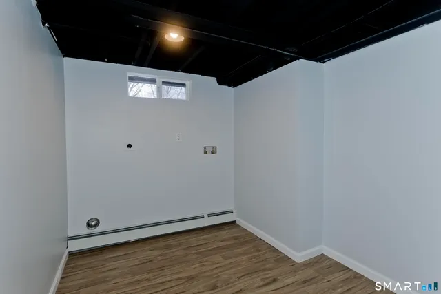 a view of an empty room with wooden floor
