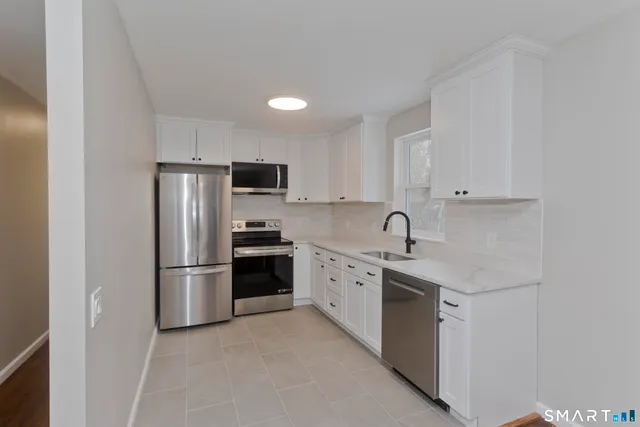 a view of a dining room with furniture and a kitchen